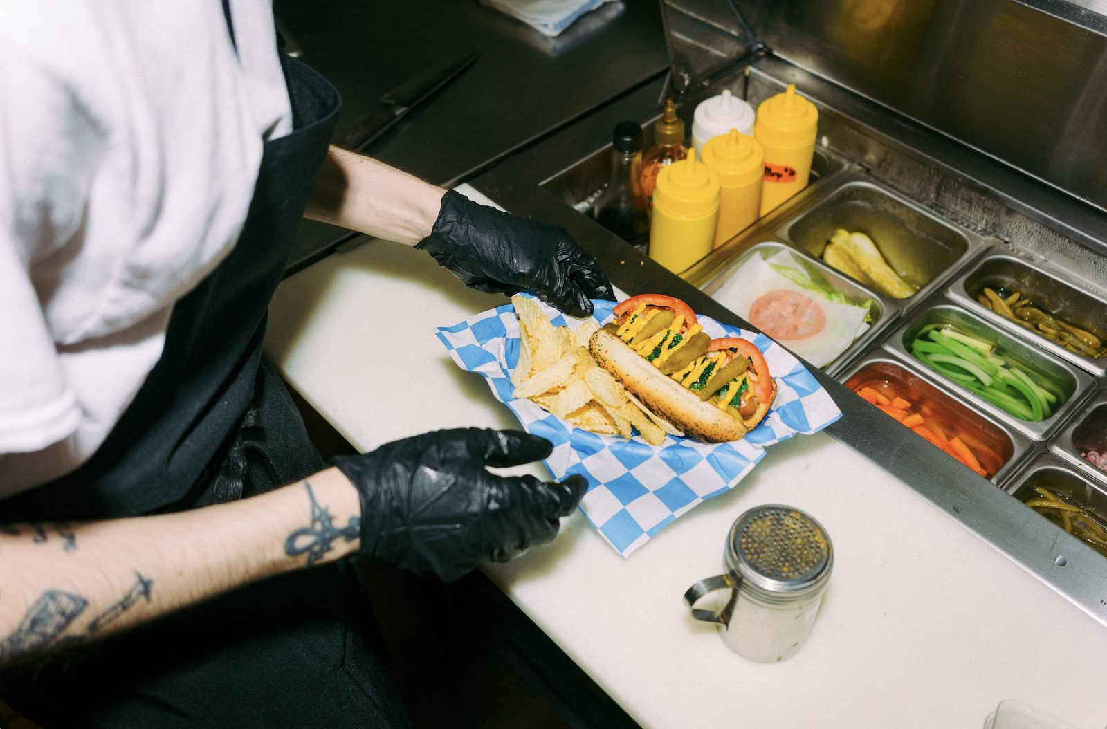 Chef plating a loaded dog